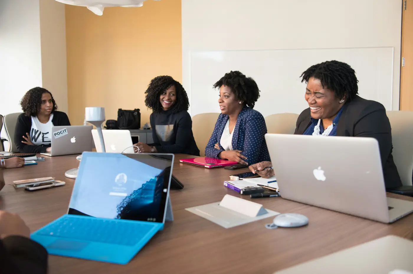 Researchers and policy professionals collaborating around laptops in a meeting room