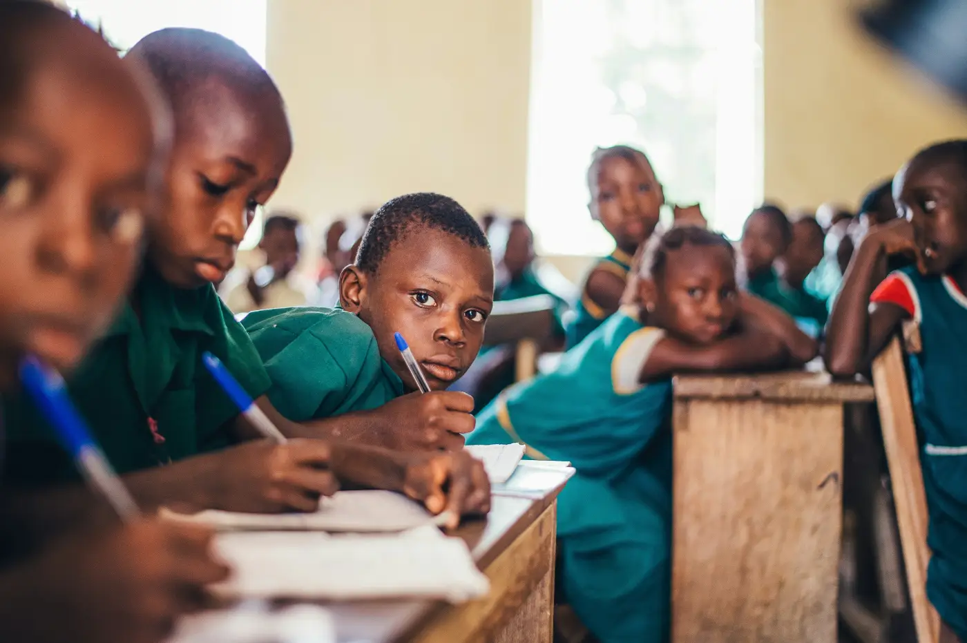 Students writing in a classroom during a capacity-building session